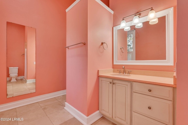 bathroom with vanity, tile patterned floors, and toilet