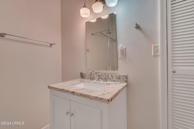 bathroom with walk in shower and vanity