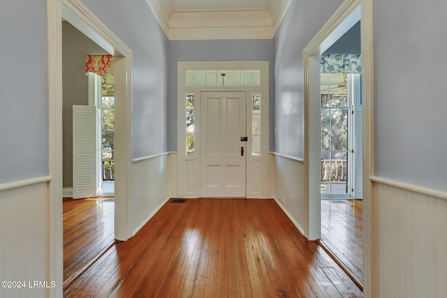 entryway featuring hardwood / wood-style flooring and ornamental molding