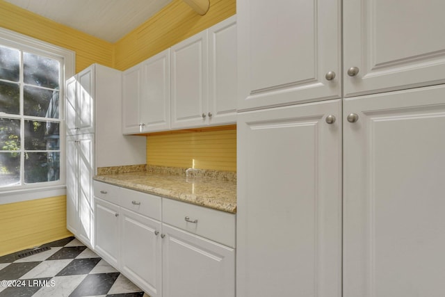 kitchen with white cabinets and light stone counters