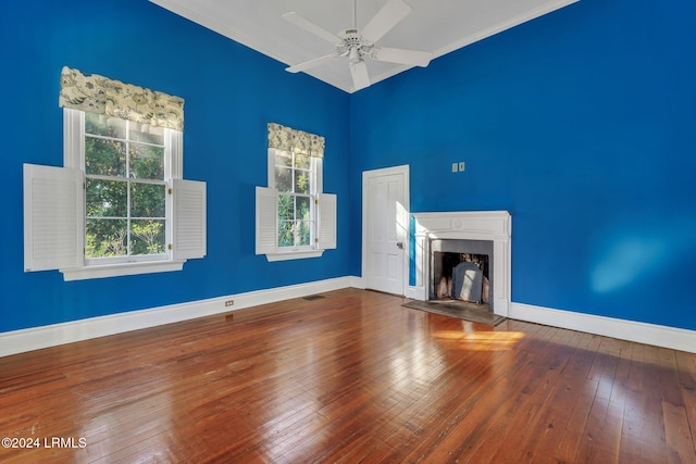 unfurnished living room with hardwood / wood-style floors and ceiling fan