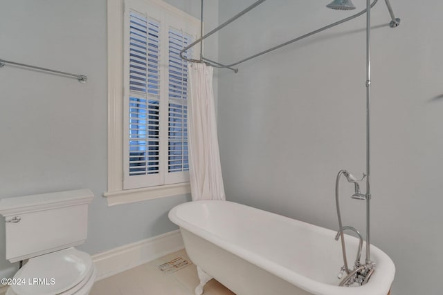 bathroom featuring a bath, tile patterned floors, and toilet