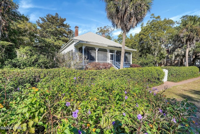 view of front of property featuring a sunroom