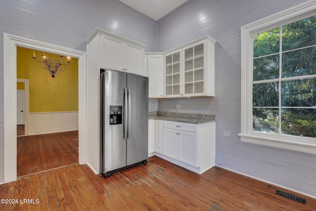 kitchen featuring white cabinetry, stainless steel fridge with ice dispenser, dark wood-type flooring, and dark stone countertops