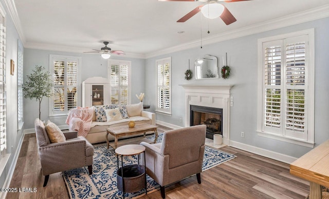 living area with ornamental molding, plenty of natural light, and wood finished floors