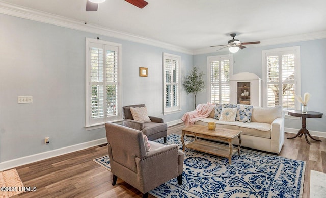 living room featuring a healthy amount of sunlight, crown molding, and wood finished floors