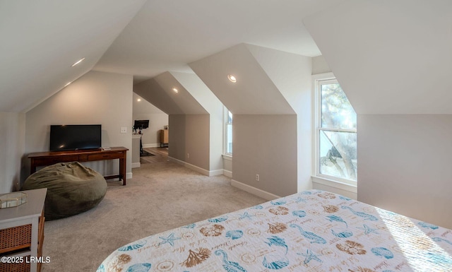 bedroom with vaulted ceiling, carpet flooring, and baseboards