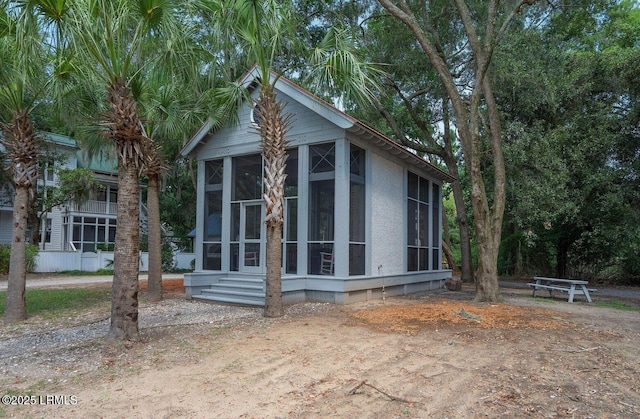 view of home's exterior with a sunroom