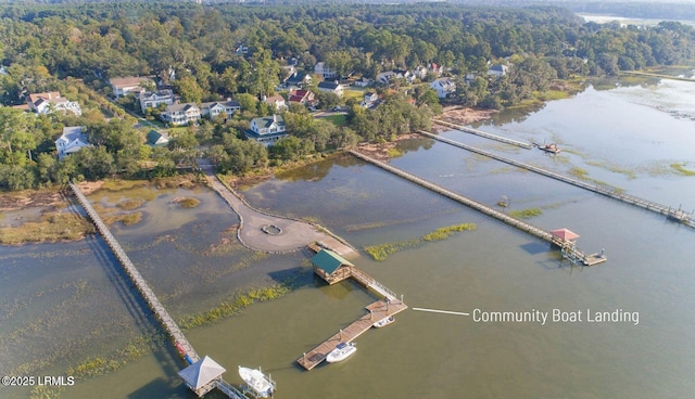 aerial view with a water view and a forest view