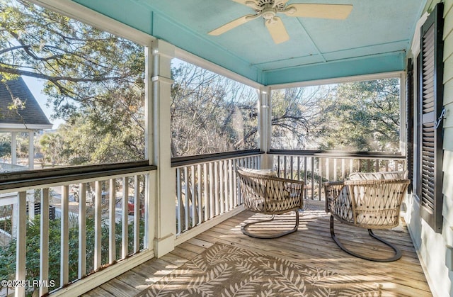 sunroom / solarium featuring ceiling fan