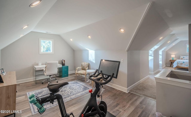 exercise room with recessed lighting, vaulted ceiling, baseboards, and wood finished floors