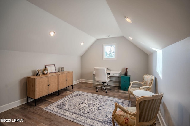 office featuring lofted ceiling, visible vents, baseboards, and wood finished floors