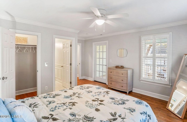 bedroom featuring ceiling fan, ornamental molding, wood finished floors, and baseboards