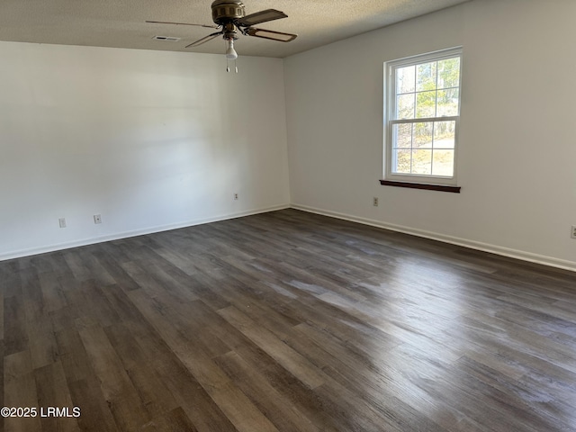 spare room with ceiling fan, dark wood-type flooring, and a textured ceiling