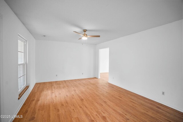 unfurnished living room featuring hardwood / wood-style flooring, built in features, ceiling fan, a textured ceiling, and a brick fireplace