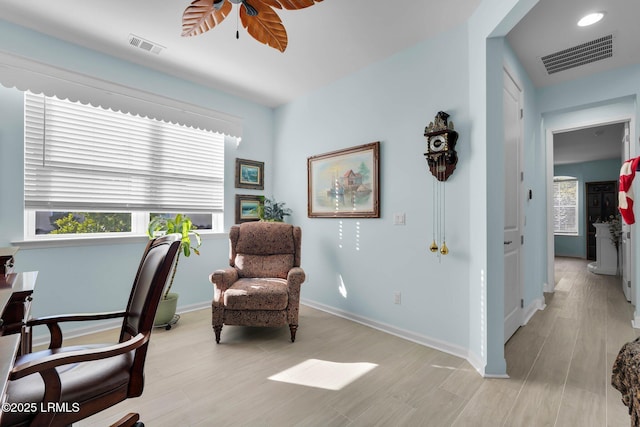 home office featuring ceiling fan, light wood-type flooring, and a wealth of natural light