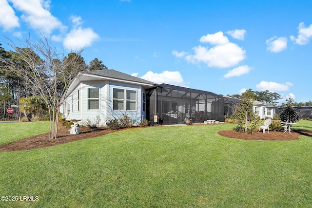 view of front facade with a front lawn and glass enclosure