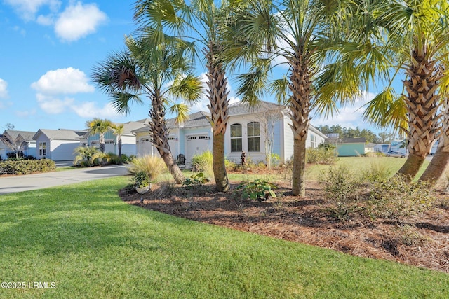 view of front facade with a garage and a front yard