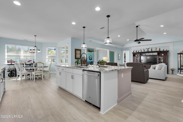 kitchen featuring dishwasher, an island with sink, sink, white cabinets, and hanging light fixtures