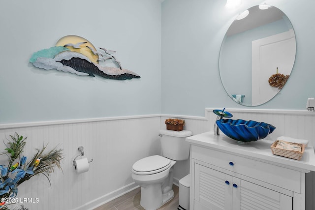 bathroom featuring hardwood / wood-style flooring, vanity, and toilet