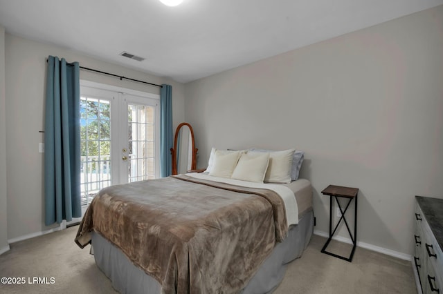 carpeted bedroom featuring french doors and access to outside