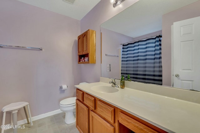 bathroom with vanity, toilet, and curtained shower