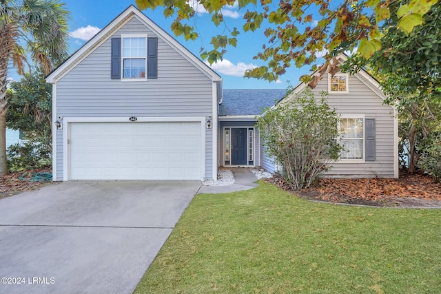 front of property with a garage and a front lawn