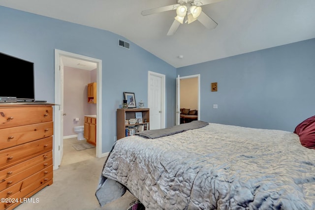 carpeted bedroom with ceiling fan, ensuite bath, and lofted ceiling