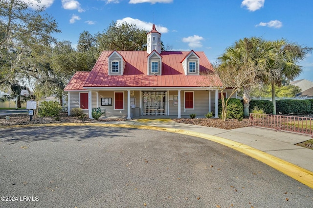 cape cod house featuring a porch