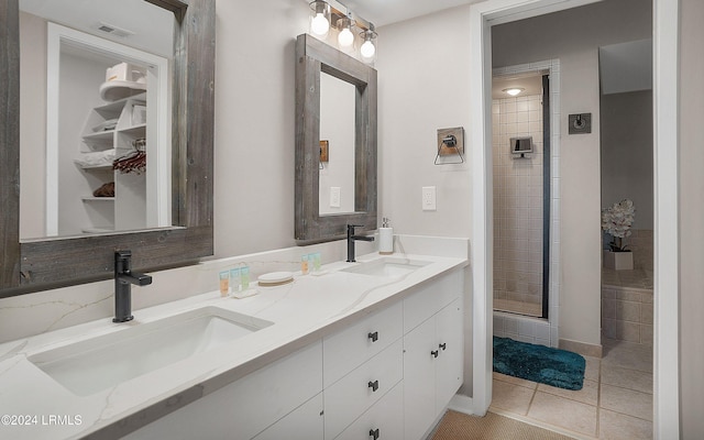 bathroom with vanity, tile patterned flooring, and a shower with door