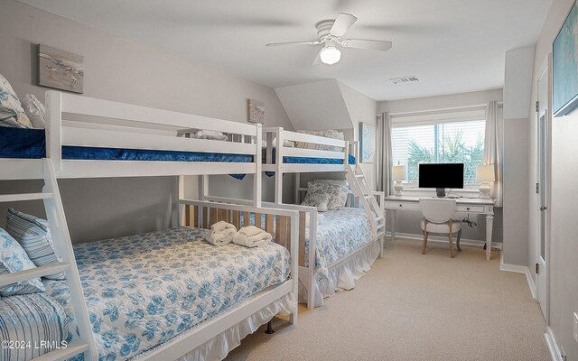 carpeted bedroom with vaulted ceiling and ceiling fan