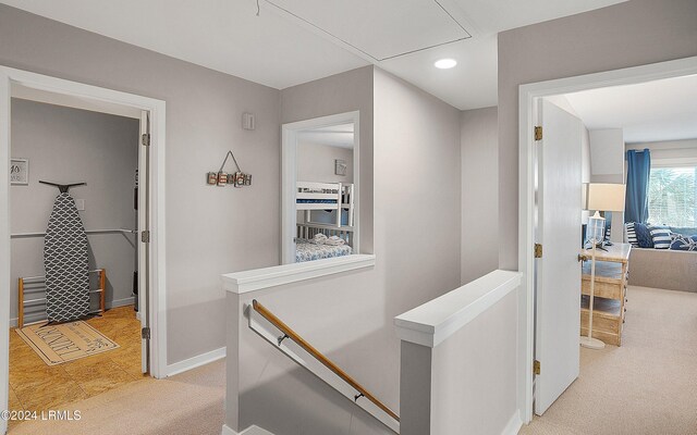 hallway featuring light colored carpet