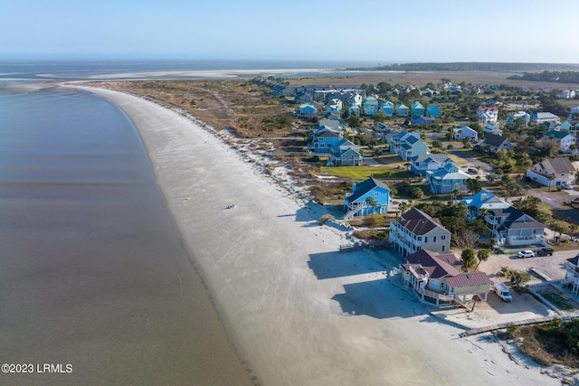 drone / aerial view featuring a water view and a view of the beach