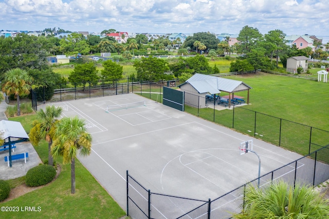 view of sport court with a lawn