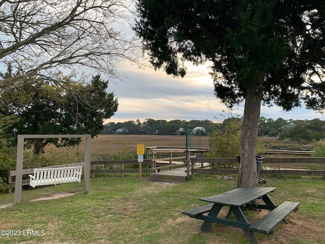 view of home's community with a rural view and a lawn