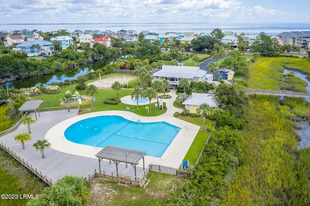 view of pool featuring a water view, a patio area, and a pergola