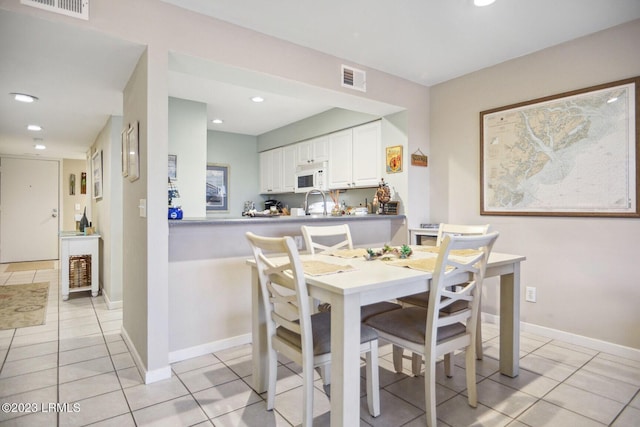 tiled dining room with sink