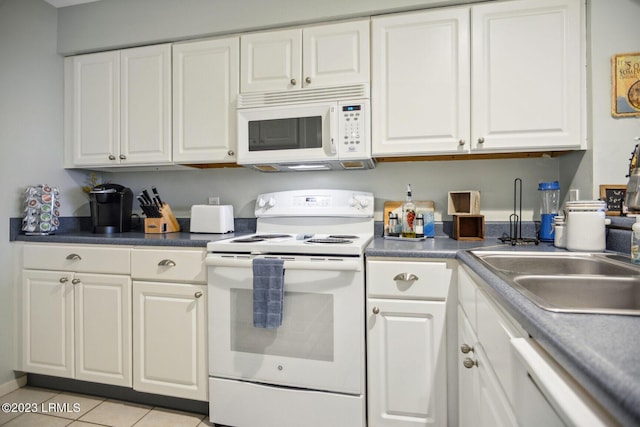 kitchen featuring light tile patterned floors, white appliances, sink, and white cabinets