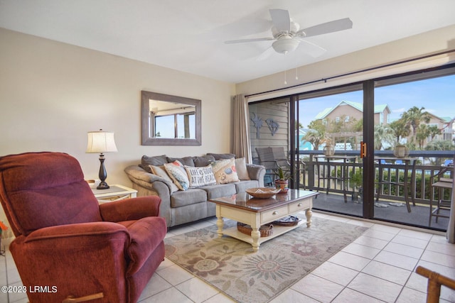 living room featuring a wealth of natural light, light tile patterned floors, and ceiling fan