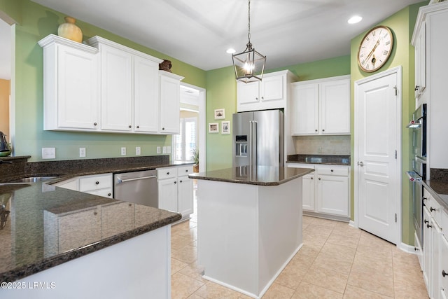 kitchen featuring appliances with stainless steel finishes, white cabinets, and light tile patterned floors