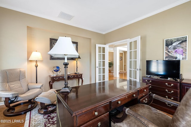 home office featuring french doors, wood finished floors, visible vents, and crown molding