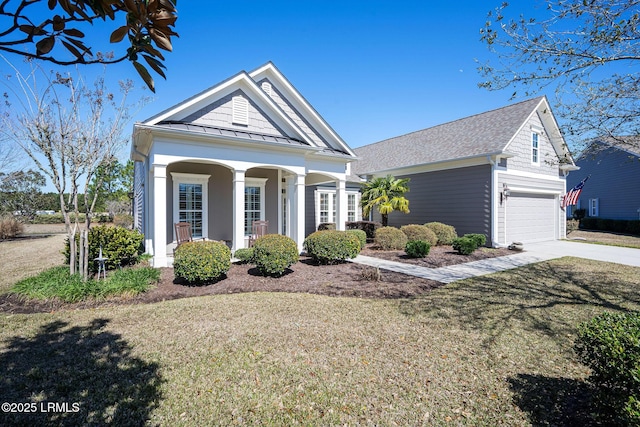 neoclassical / greek revival house with a shingled roof, a front yard, a standing seam roof, metal roof, and driveway