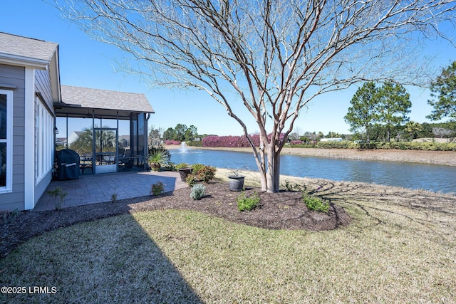 view of yard featuring a water view and a sunroom