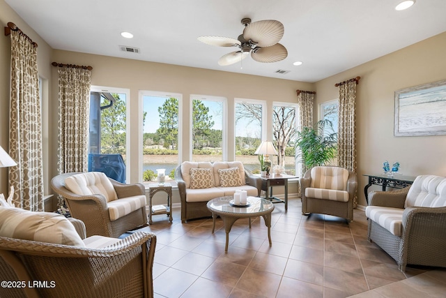 sunroom with visible vents and ceiling fan