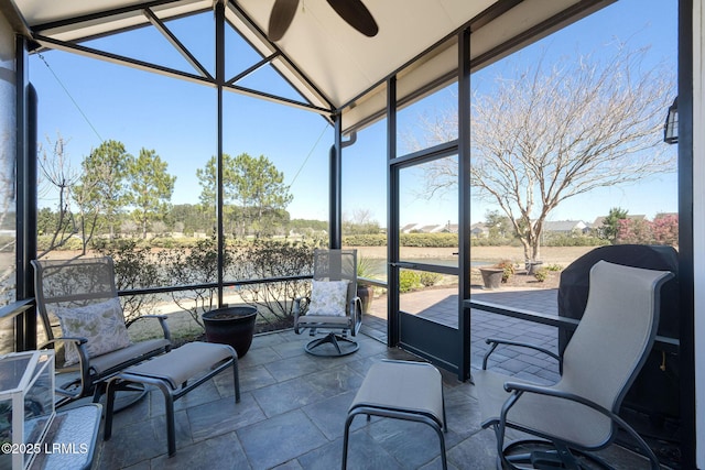 sunroom featuring vaulted ceiling and ceiling fan