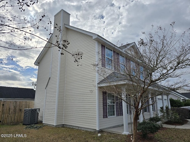 view of side of home with central air condition unit