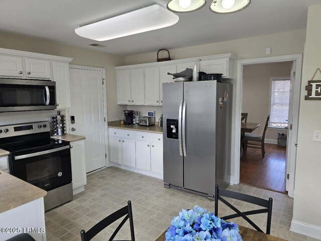 kitchen with white cabinets and stainless steel appliances