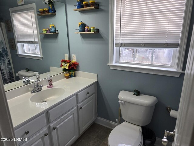 bathroom featuring tile patterned floors, plenty of natural light, toilet, and vanity