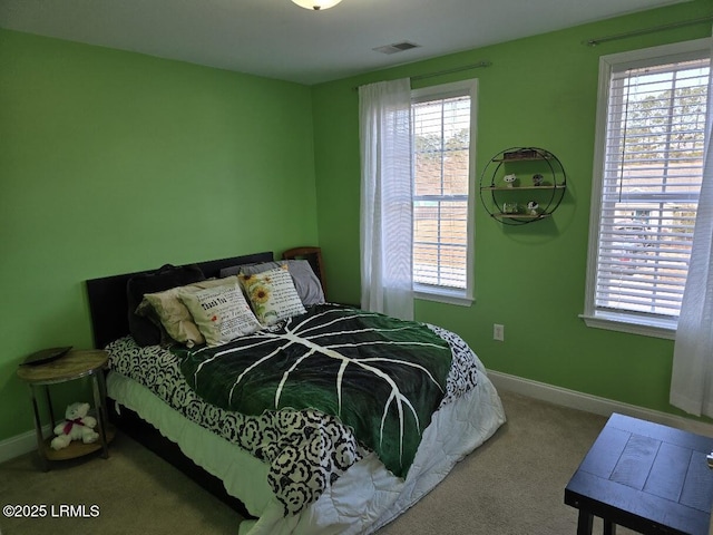 carpeted bedroom featuring multiple windows