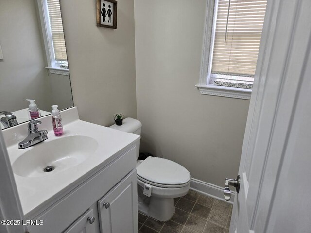 bathroom featuring toilet, vanity, and tile patterned flooring